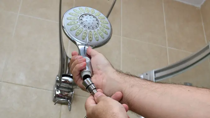 Installing a new shower hose on an used showerhead.