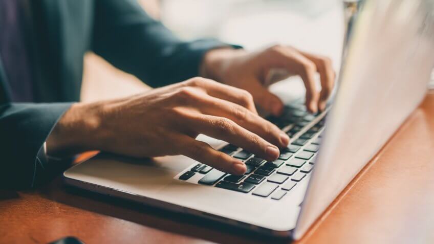 Close up of a hands of a businessman on a keyboard.