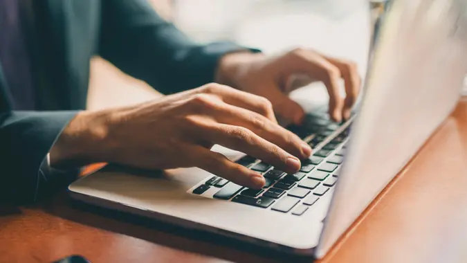 Close up of a hands of a businessman on a keyboard.