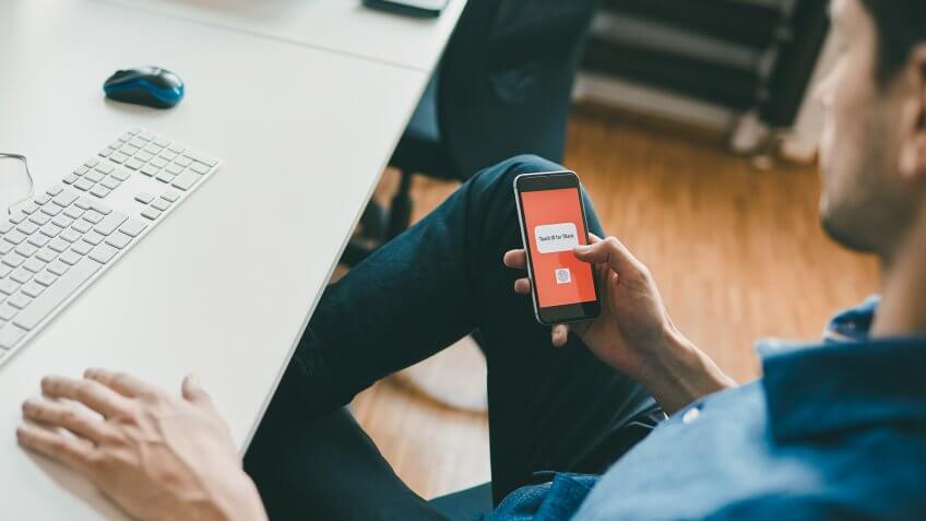 man using touch id on smartphone.