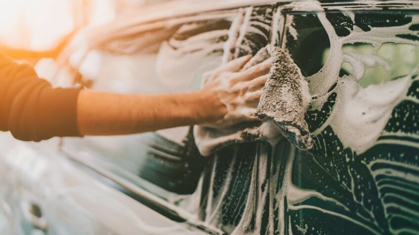 man soaping his car.