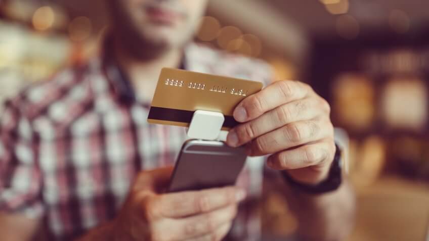 Man making mobile payment ++++ Note for the inspector: Credit card is fake and is made especially for the photosession ++++.