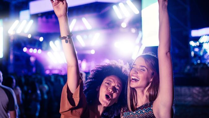 Two young women having fun at a music festival.