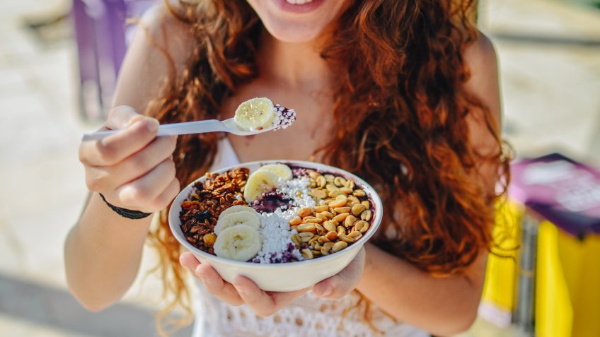 woman eating breakfast bowl