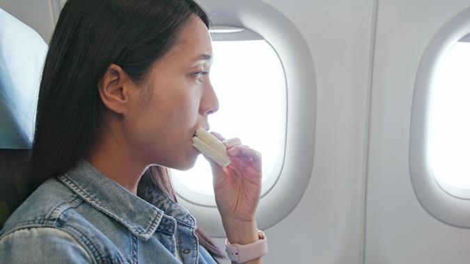 woman eating on airplane