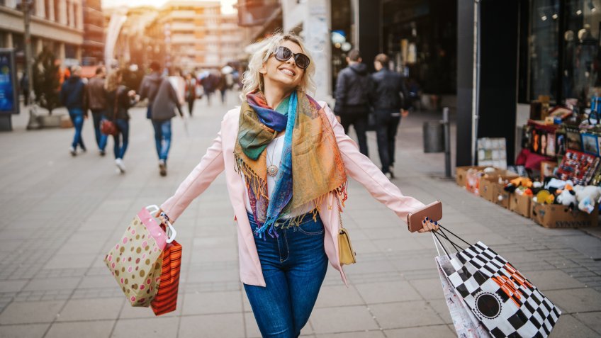 Happy young woman in shopping.