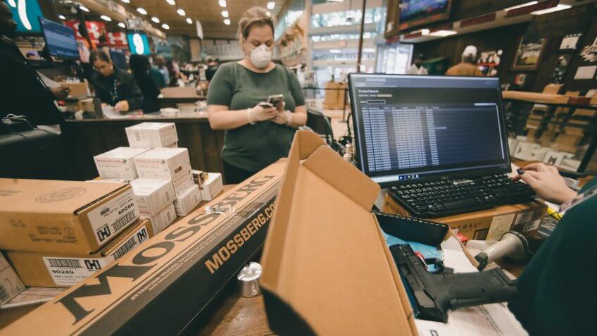 Mandatory Credit: Photo by John Bazemore/AP/Shutterstock (10585117b)Stephanie Miller of Atlanta, buys guns and ammunition for them at Adventure Outdoors, in Smyrna, Ga.