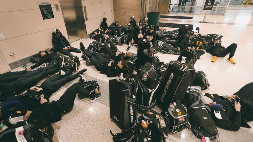 Mandatory Credit: Photo by Charles Rex Arbogast/AP/Shutterstock (10581406a)Players with the University of Missouri baseball team wait in the baggage claim area of Chicago's Midway Airport, only to arrive in Chicago and then get notified that the team's SEC Conference opener with Alabama Friday, had been canceledVirus Outbreak College Baseball, Chicago, United States - 12 Mar 2020.
