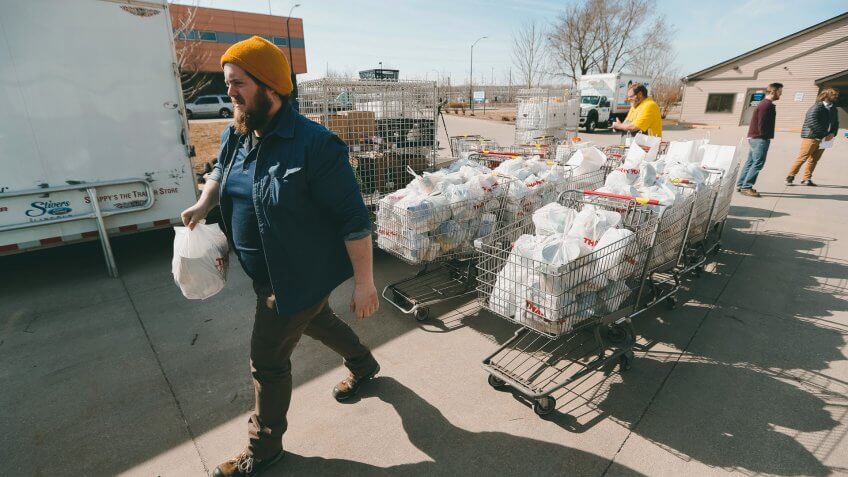 Mandatory Credit: Photo by Charlie Neibergall/AP/Shutterstock (10587213c)Patrick Minor loads food onto a delivery truck at the Des Moines Area Religious Council food pantry in Des Moines, Iowa.