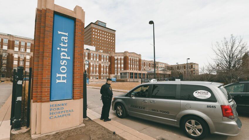 Mandatory Credit: Photo by Paul Sancya/AP/Shutterstock (10584804d)Security guard screens visitors before entering Henry Ford Hospital in Detroit, .