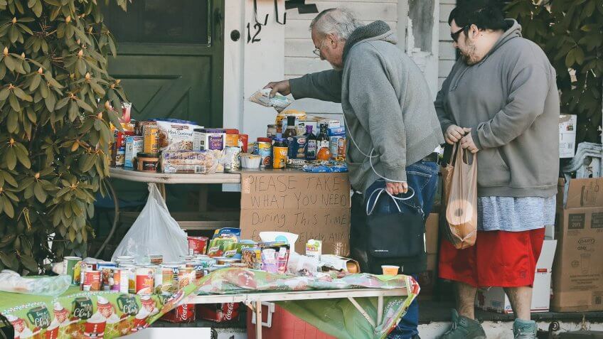 Mandatory Credit: Photo by Charles Krupa/AP/Shutterstock (10587538b)Two residents select items on a community table, filled with groceries for those in need, in Derry, N.