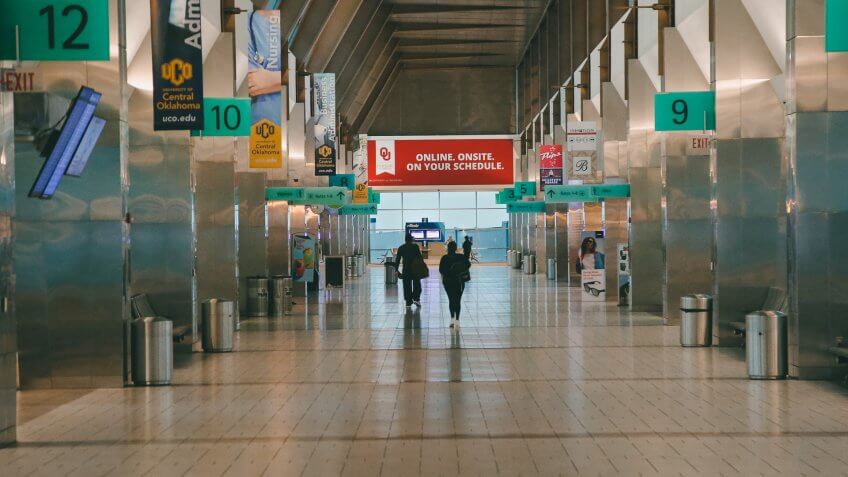 Mandatory Credit: Photo by Sue Ogrocki/AP/Shutterstock (10586634a)Passengers walk through a nearly empty concourse at Will Rogers World Airport in Oklahoma City, as airlines limit flights due to the virus outbreakVirus Outbreak Oklahoma Airports, Oklahoma City, United States - 17 Mar 2020.