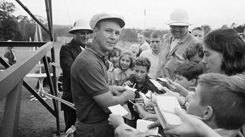 Arnold Palmer obliges the kids with autographs following practice round for the Masters Golf Tournament in Augusta, Ga.