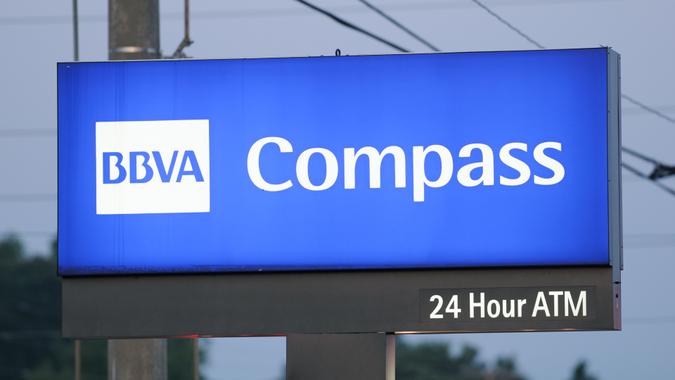 Huntsville, Alabama, USA - August 3, 2011: Close up of illuminated BBVA Compass sign at sunrise.
