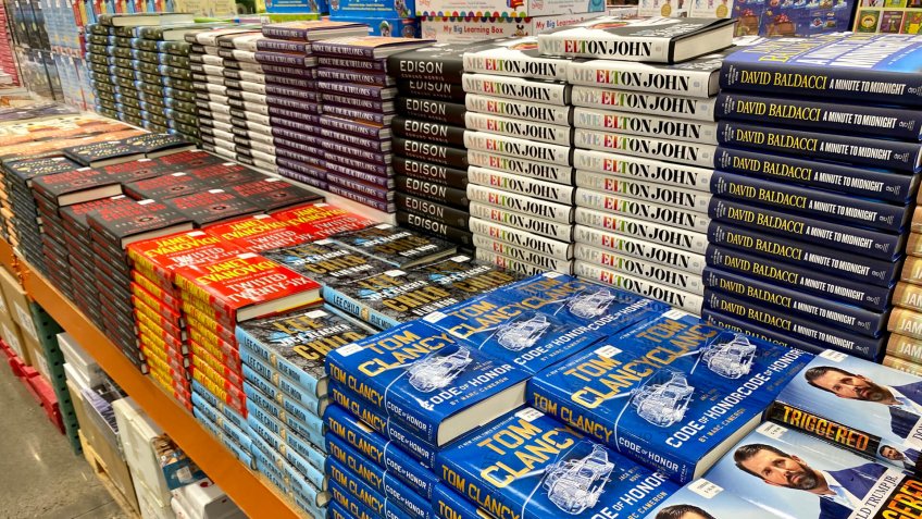 San Jose, CA - December 6, 2019: Stacks of hard cover books at Costco including titles by authors like Janet Evanovich, Tom Clancy and Donald Trump Jr.