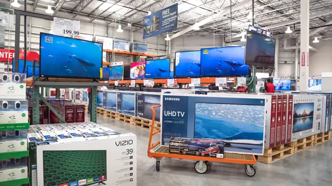 HUMBLE, TX, US-NOV 25, 2016: Costco Wholesale with row of big screen, smart TVs display on shelves and on flatbed cart.