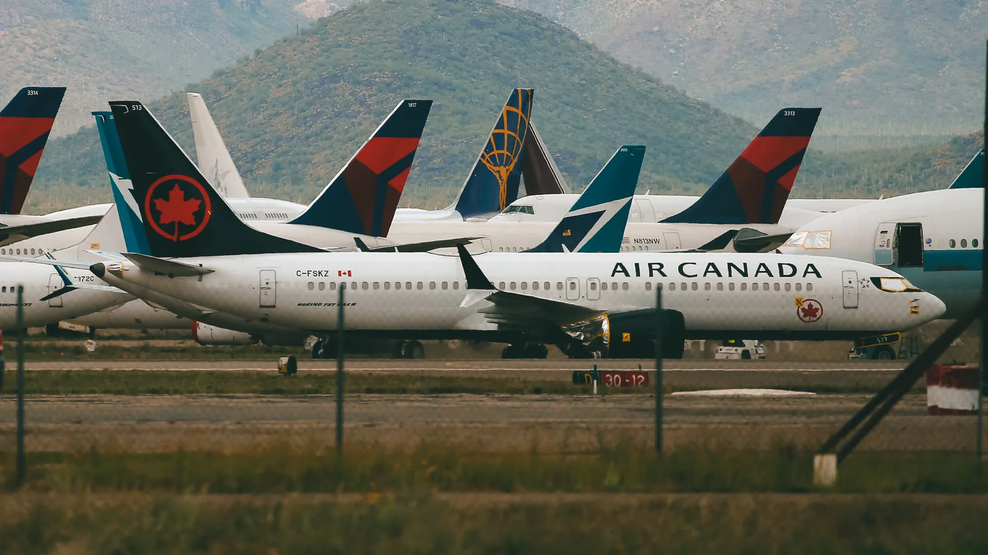 Recently landed passenger planes are parked at Pinal Airpark, in Red Rock, Ariz.