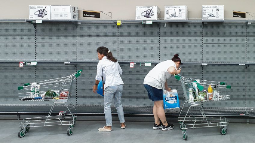 Gold Coast, Australia - March 9, 2020: Supermarket empty toilet paper shelves amid coronavirus fears, shoppers panic buying and stockpiling toilet paper preparing for a pandemic.