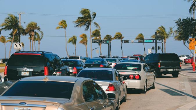 Fort Lauderdale, Florida, USA - March 23, 2013: Intersection at Sunrise Boulevard and State Road A1A near the beach during the day with many vehicles waiting for the traffic signal during spring break.