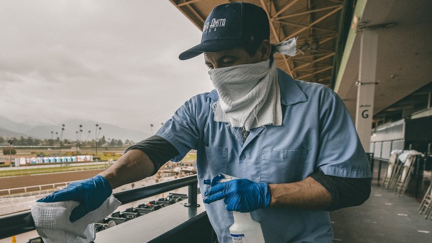 An unidentified worker sanitizes the grandstand handrails despite being closed to the public for safety concerns over the coronavirus in Arcadia, California on Evers/Eclipse Sportswire/CSMHorse Racing Horse Racing continues despite COVID19, Arcadia, USA - 14 Mar 2020.