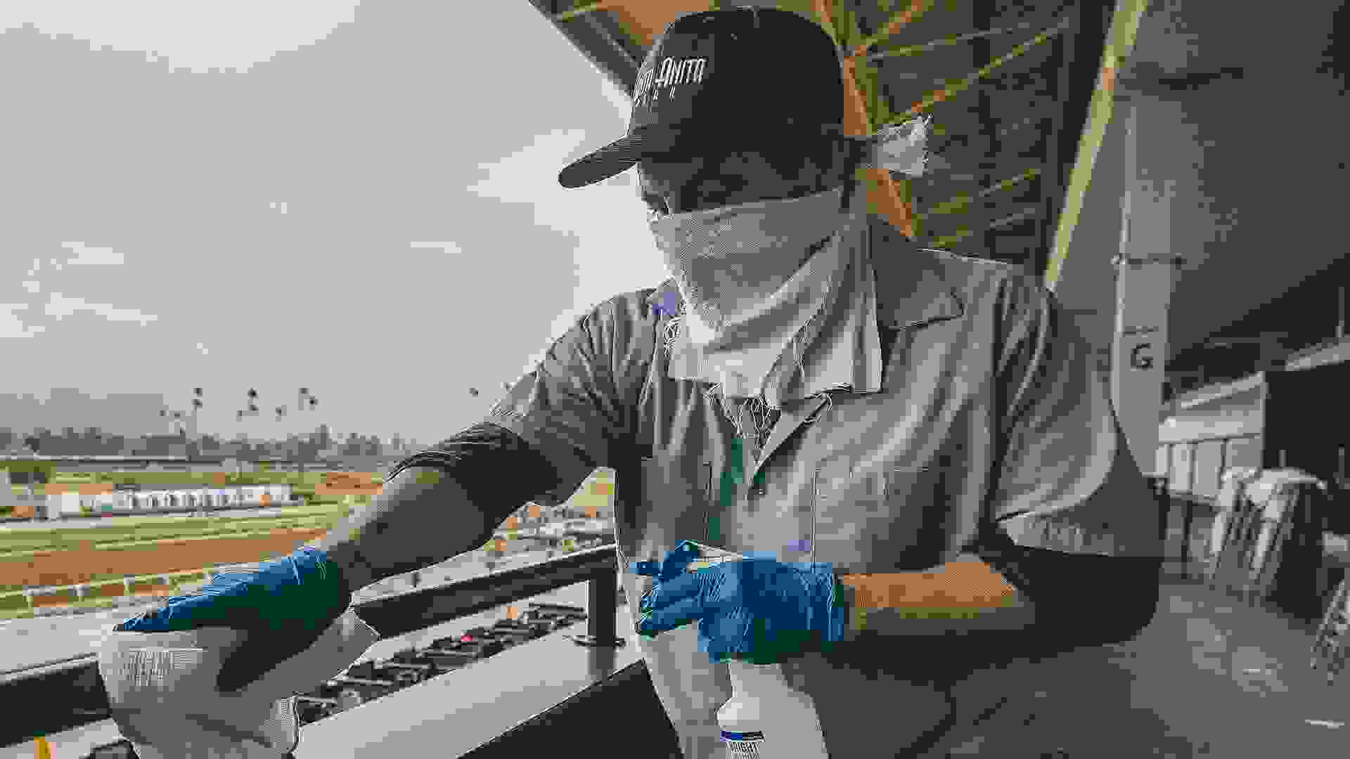 An unidentified worker sanitizes the grandstand handrails despite being closed to the public for safety concerns over the coronavirus in Arcadia, California on Evers/Eclipse Sportswire/CSMHorse Racing Horse Racing continues despite COVID19, Arcadia, USA - 14 Mar 2020.