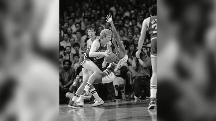Boston's Larry Bird knocks over Milwaukee Junior Bridgeman as he heads for the basket during National Basketball Association Playoff Action, Monday night, in Milwaukee.