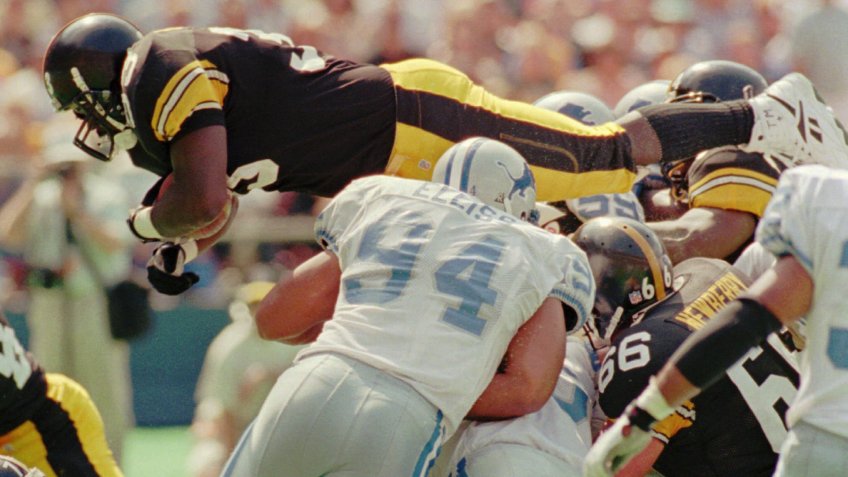 Mandatory Credit: Photo by Gene J Puskar/AP/Shutterstock (6518563a)MORRIS ELLISS Pittsburgh Steelers running back Bam Morris, top, flies over Detroit Lions' Luther Elliss (94) and the rest of the defense for one of his two touchdowns in Sunday's 23-20 winLIONS STEELERS, PITTSBURGH, USA.