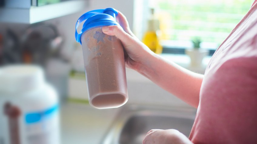 Taking protein drink in shaker to mix up the ingredients.