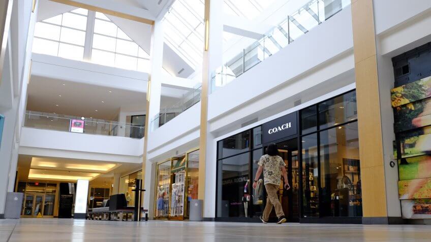 Visitor walks in an empty hallway at The Fashion Mall at Keystone, in Indianapolis.