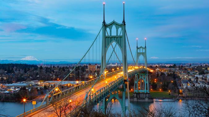 St Johns Bridge over the Willamette River in Portland, Oregon with Mt St Helens and Mt Adams in the background.