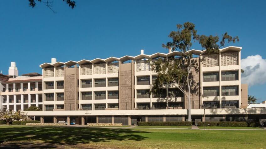 Santa Barbara, California, USA - January 6, 2019: The white and beige modern chemistry building of UCSB, behind green lawn and under blue sky.