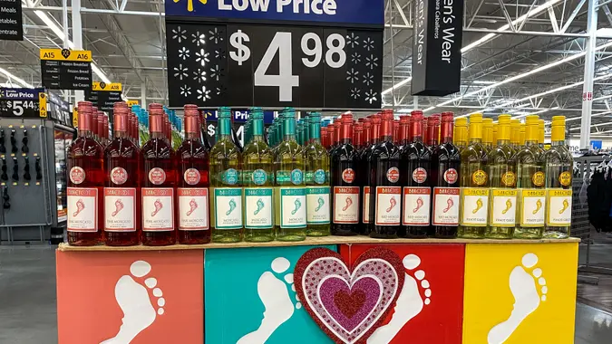 Orlando, FL/USA-2/6/20: Cases of bottles of Red, Pink and White Moscato and Pinot Grigio Barefoot Wine is manufactured in California by Barefoot Cellars displayed for sale at a Walmart store.