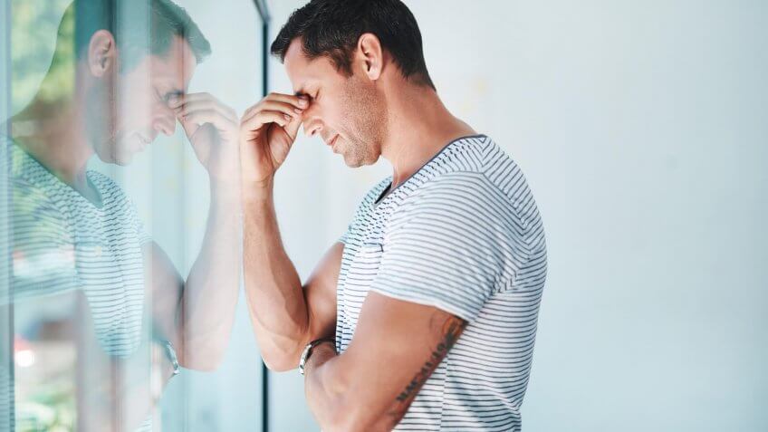 Shot of a mature businessman looking stressed out in an office.