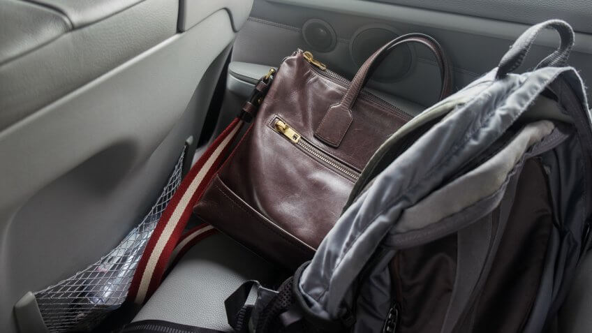 Rucksack and bag left on a car backseat.