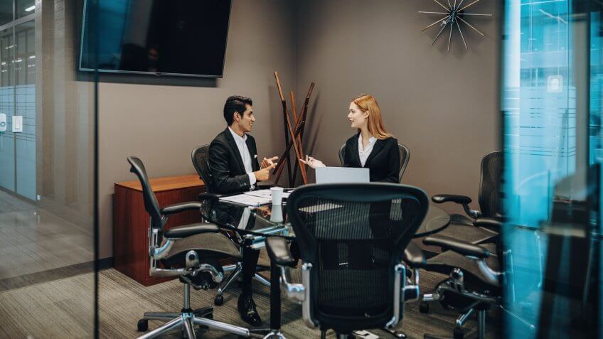 Latin/Hispanic business people in America establishing new contacts, working together and applying academic knowledge to make successful decisions in business.