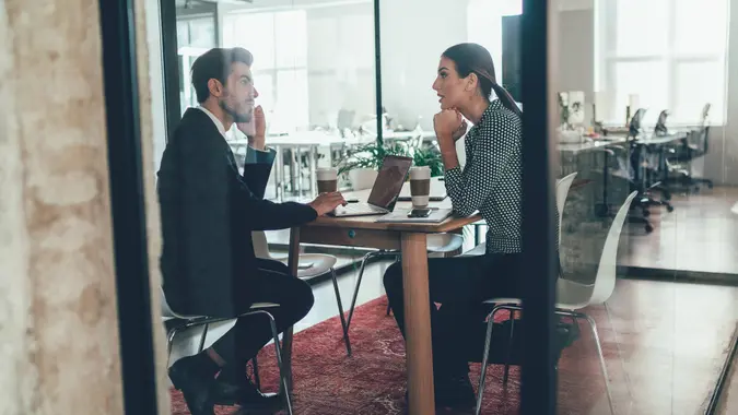 Businessman and business woman talking in the office.