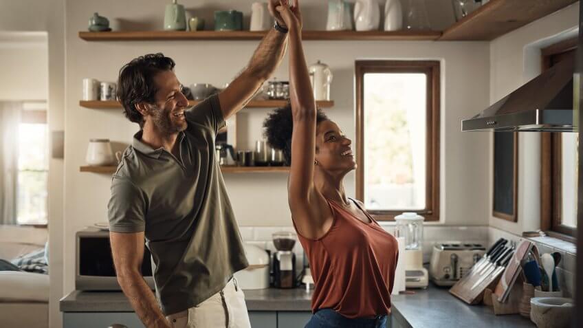 Cropped shot of an affectionate young couple dancing together in their kitchen at home.