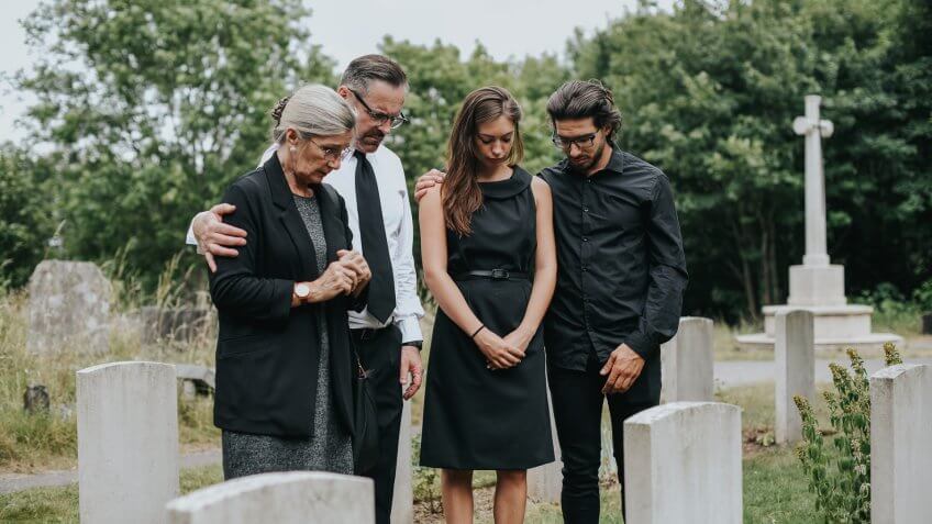 Family giving their last goodbyes at the cemetery.