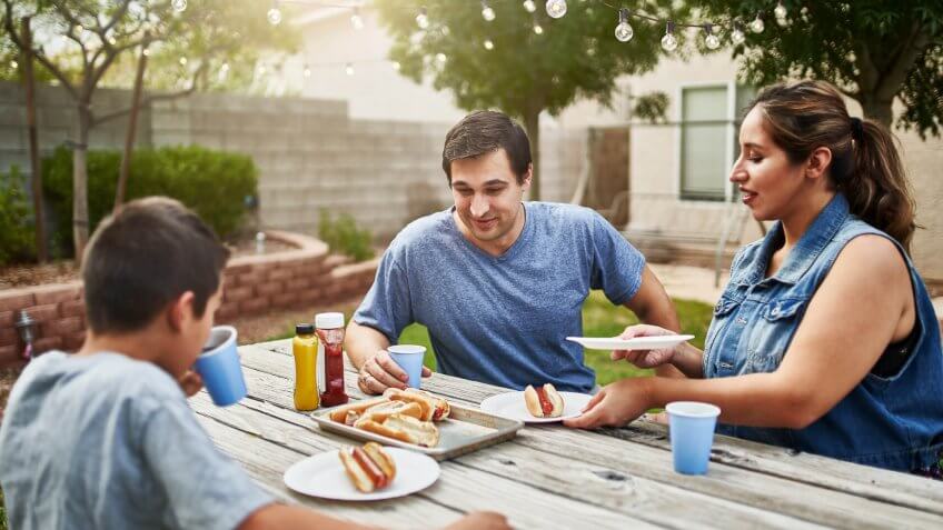 family in backyard picnic table