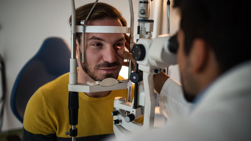Young men having an eye exam at ophthalmologist's office.