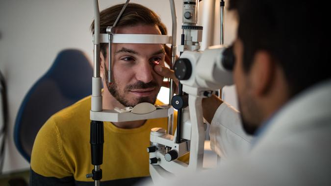 Young men having an eye exam at ophthalmologist's office.