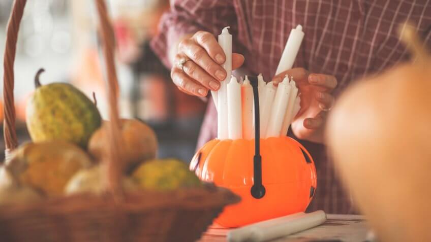 Selecting and placing candles for Halloween decorations.
