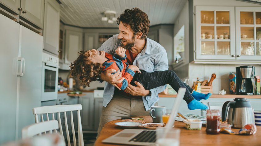 Close up of a family having breakfast and playing with each other.