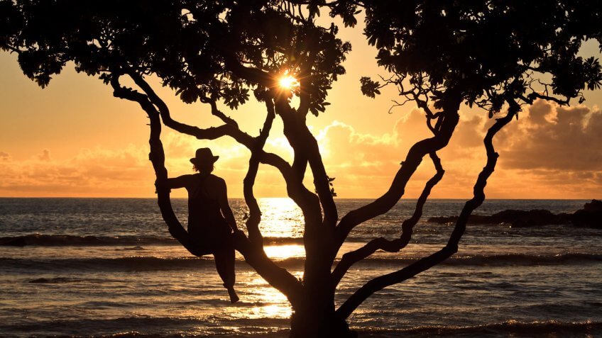 A caucasian women relaxing on a tropical beach in Hawaii.