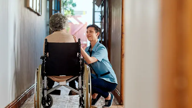 Shot of a nurse caring for a senior patient in a retirement home.