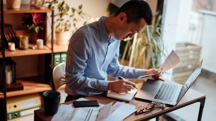 Man calculating his financial bills.