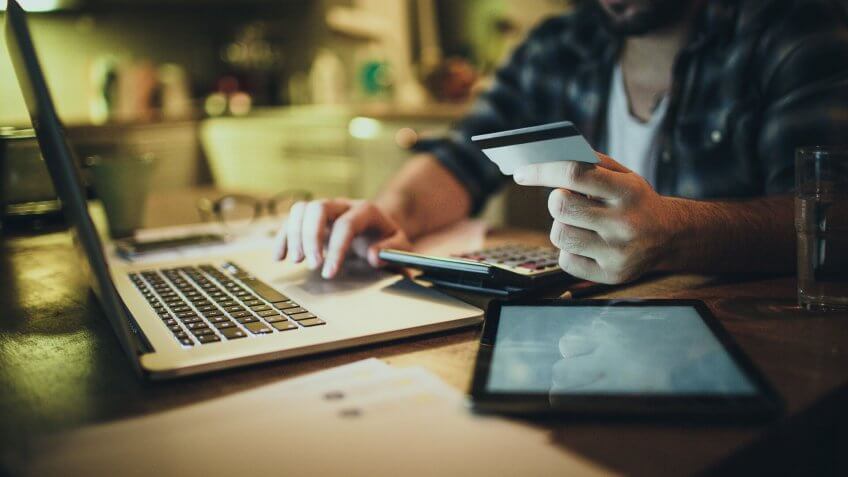 Photo of a man paying bills online.
