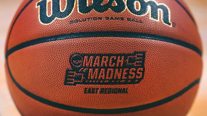 The "March Madness" logo adorns a ball resting on the court during practice at the NCAA men's college basketball tournament in BostonNCAA Basketball, Boston, USA - 22 Mar 2018.