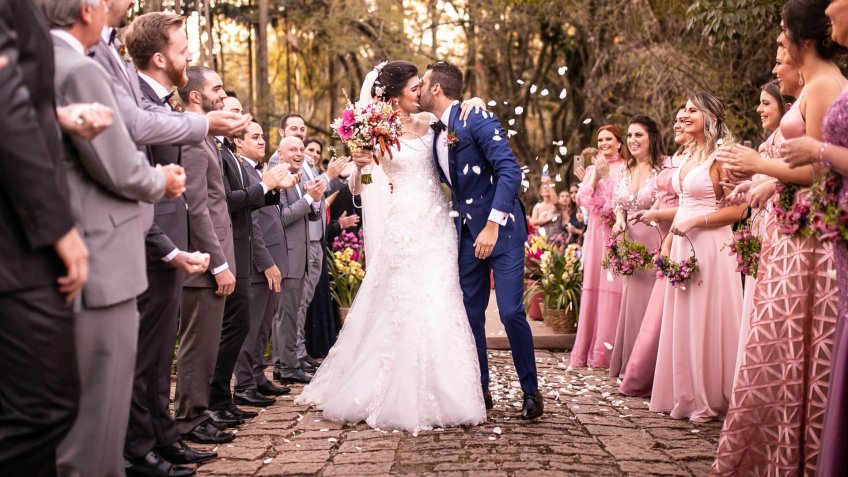 Confetti throwing on happy newlywed couple.