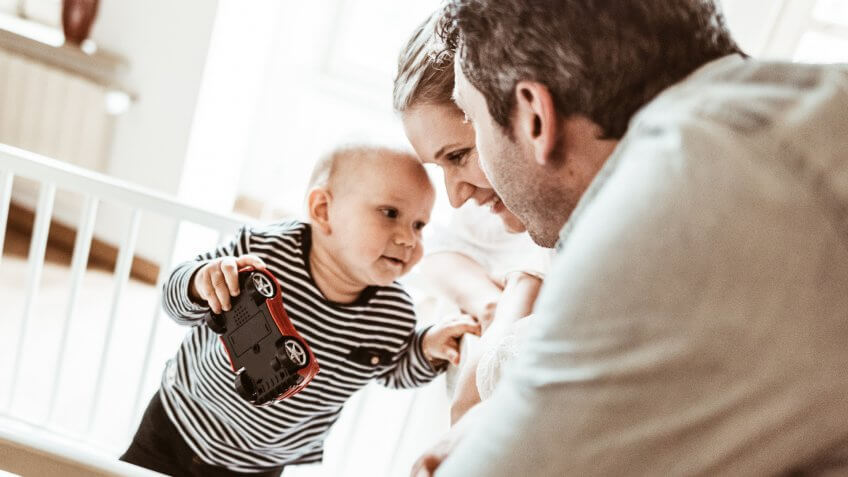 happiness family with son in the crib.